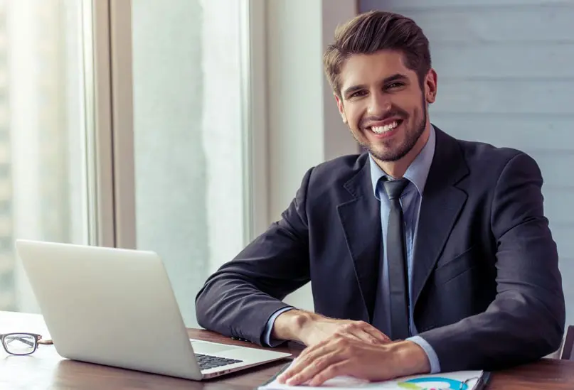 A man sitting at his desk with a laptop.